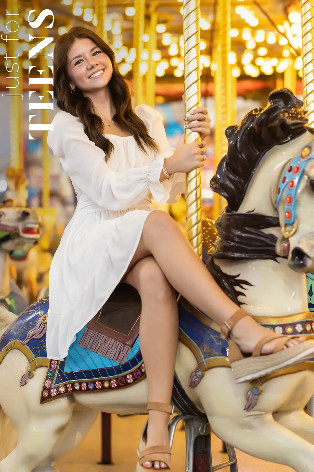 Smiling teen girl on a carousel horse during a photo shoot in Phoenix, Arizona.