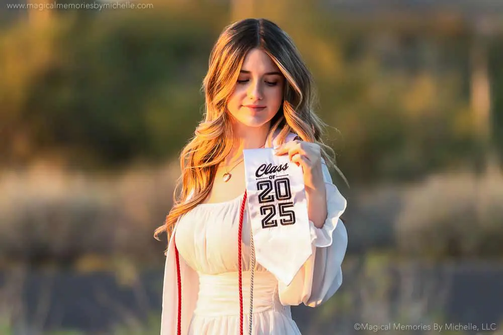 Senior girl poses in soft golden hour light at a scenic desert location in Arizona, perfect for senior portraits.