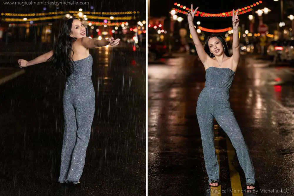 Senior girl wearing a sparkly jumpsuit at night, dancing in the rain with city lights behind her.