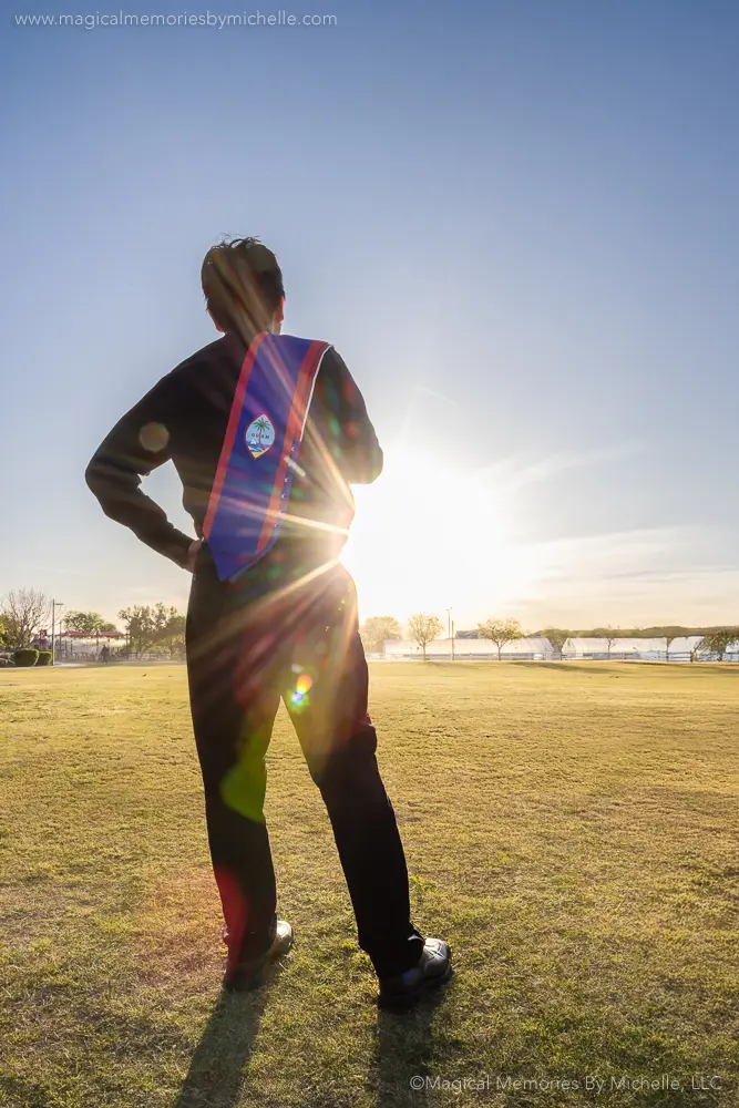 Senior boy wearing a Guam stole during a creative graduation photo shoot at sunset in Mesa, Arizona.