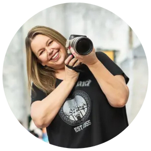 Michelle Robertson smiling and holding a camera, senior portrait photographer based in Mesa, Arizona.