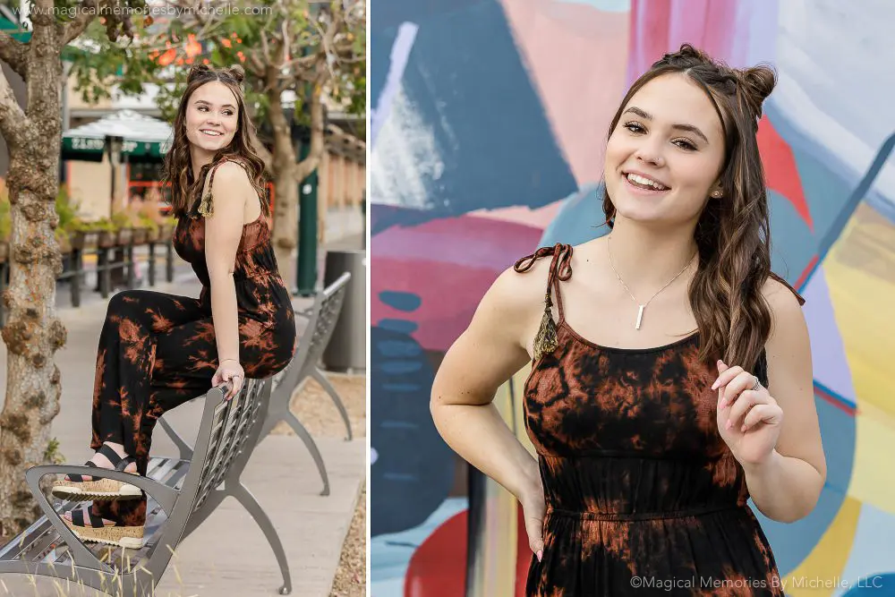 Senior girl wearing a tie-dye jumpsuit, posing confidently near a mural and bench in downtown Gilbert .