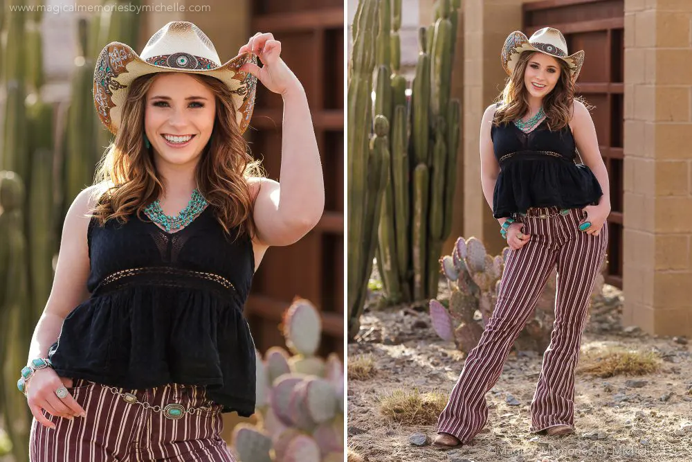 Senior girl posing with a cowboy hat, turquoise jewelry, and striped pants in front of desert cactus.