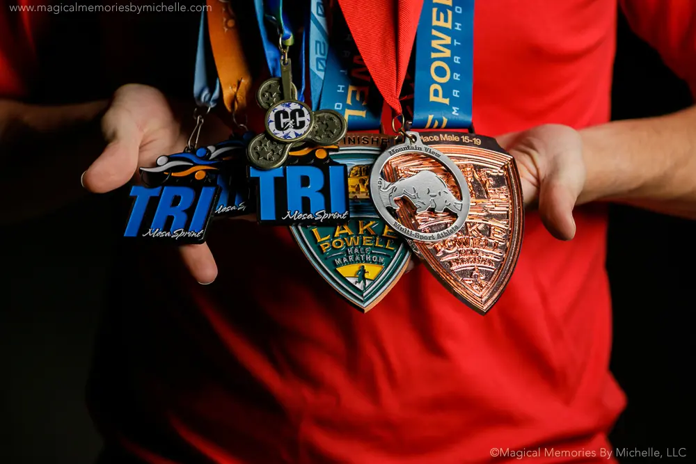 High school senior holding sports and race medals for college applications