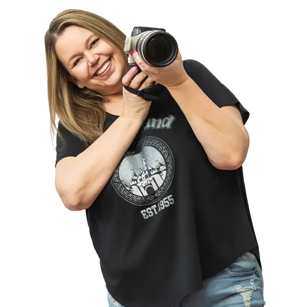 Michelle Robertson smiling and holding a camera, Mesa senior portrait photographer known for fun, personalized photo sessions.